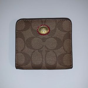 Coach Wallet with zip pocket for change.